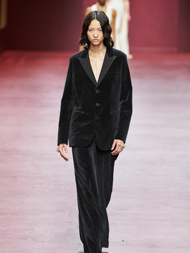 Model at the Dior runway show wearing a black velvet suit